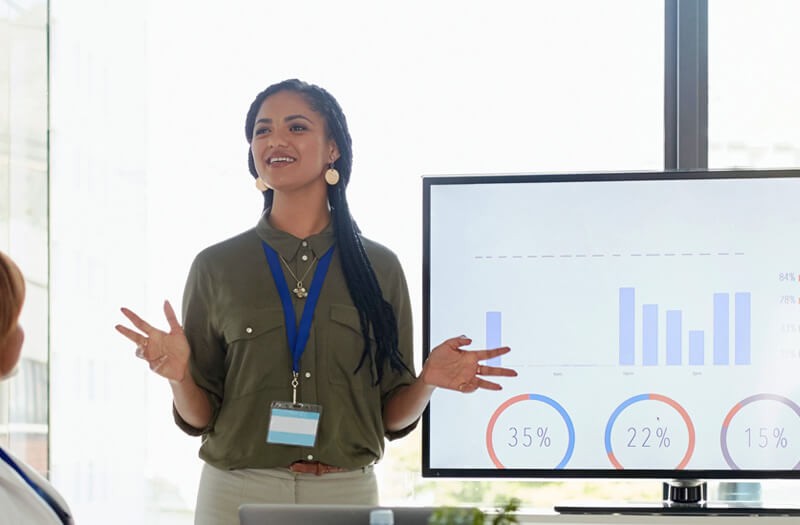 Keep up with Insight in the news and community Business women presenting in front of large monitor