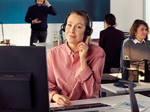 Experience All-day Comfort Male worker uses his headset in front of a laptop at night