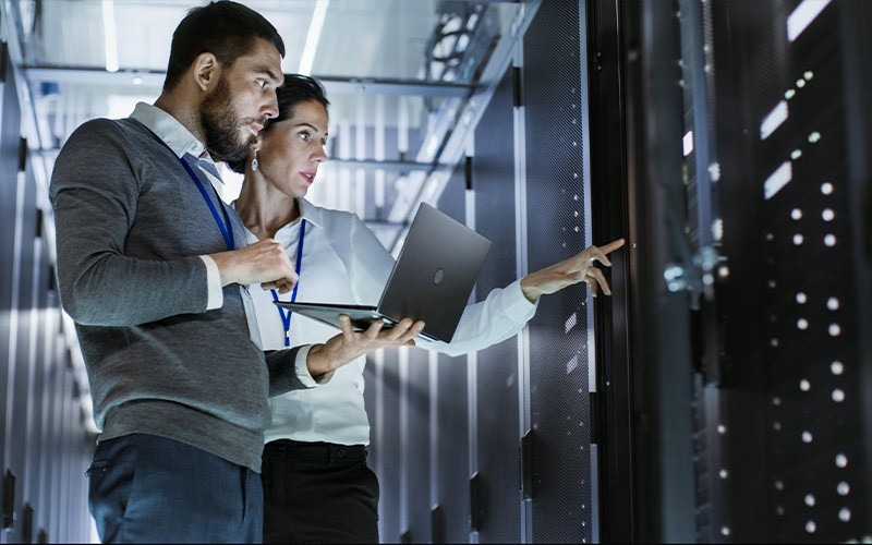 Dedication to quality man and woman working in a server room