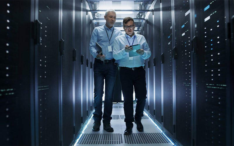 Accelerating modern data centers and hyperscale computing two colleagues walking through a data centre